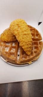 Best Chicken Tender & Waffle Belgian waffle cooked in cast iron with buttermilk 3 fried chicken tenders with a side of syrup. in Lawndale, CA